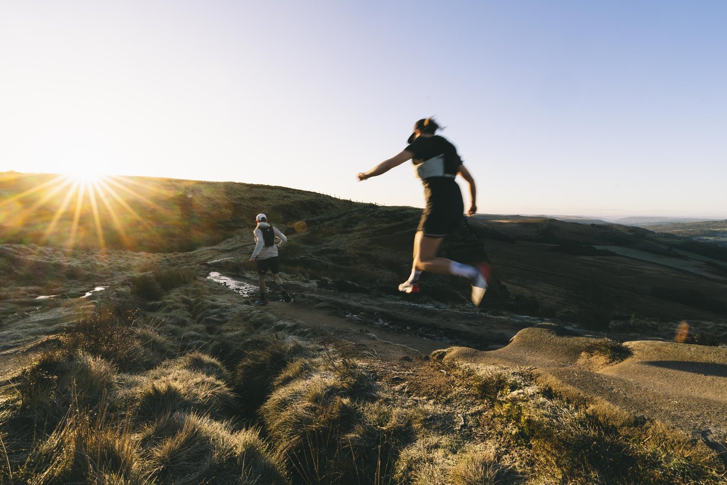 Runner on a gritstone trail at Stanage